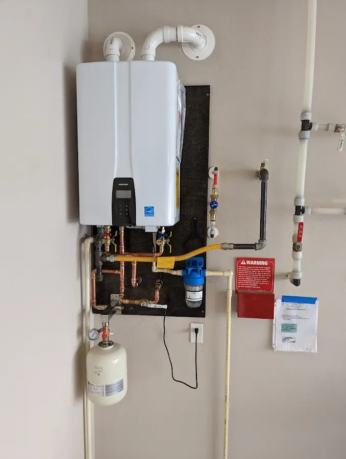 Professional plumber installing copper piping in a Hinsdale home